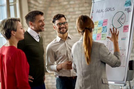 5happy-business-team-cooperating-while-analyzing-their-business-progress-whiteboard-office