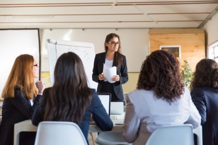 8businesswomen-looking-speaker-with-papers